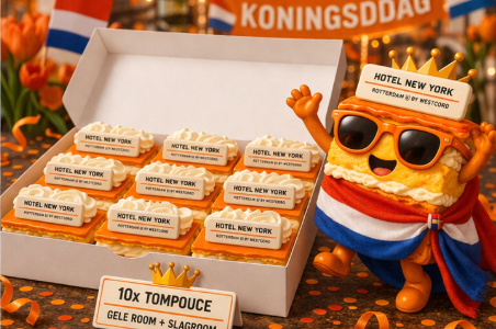 Een tompouce die juicht naast een doos tompoucen met slagroom.